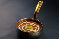 Rich and creamy dal makhani served hot in a traditional Indian pan. Perfect for food lovers.